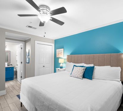 Drift off under a cooling ceiling fan, surrounded by calming ocean-inspired blues that welcome you home after a day full of local activities.