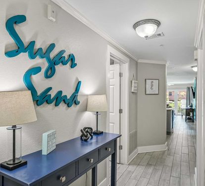 Step into your welcoming hallway, where coastal charm meets comfort. Soft lighting and serene décor set the tone for your beachside escape.