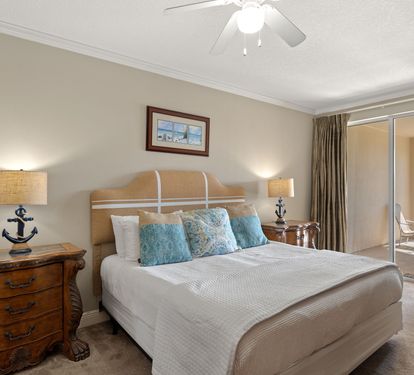 Rest peacefully in the coastal-themed bedroom with anchor-detailed lamps, plush linens, and a private balcony for morning coffee.