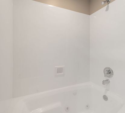 Slip into this pristine bathtub for a relaxing soak after your adventures, with clean white surroundings.