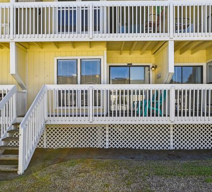 Back of condo. Steps leading to pool
