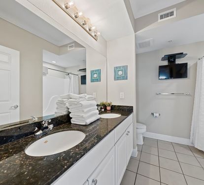 Crystal Tower 1101 Primary Bathroom with Dual Sinks and Television