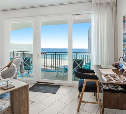 Your oceanfront retreat features floor-to-ceiling windows framing stunning sea views from your stylish living space.