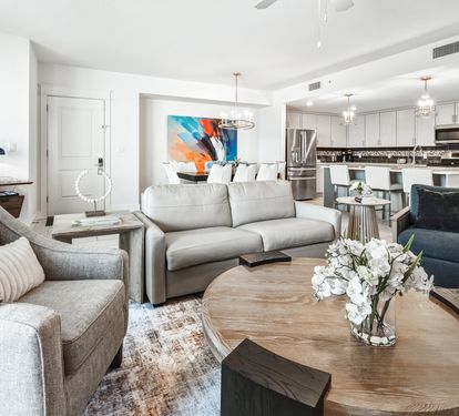 Relax in your stylish open-concept living space featuring plush seating, modern kitchen with sleek appliances, and thoughtful design touches throughout.