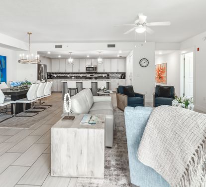 Unwind in your spacious open-concept living space, where modern comfort meets coastal style with plush seating and a fully-equipped kitchen.