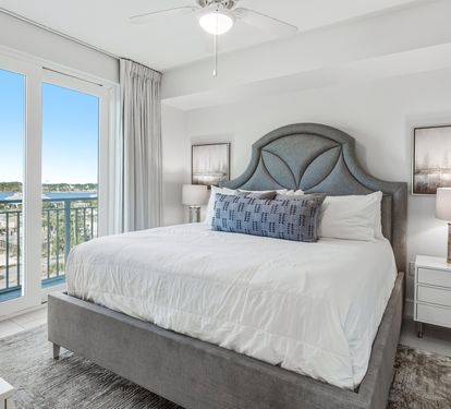 Wake up in your serene bedroom with crisp linens and stunning water views right outside your window.