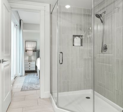 Step into your private spa-like shower with elegant glass doors and soothing gray tile that creates the perfect retreat after long days of exploring.