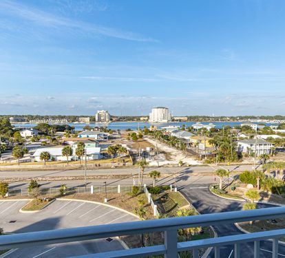 Expansive coastal view showcasing the peaceful neighborhood with waterfront access and distant high-rises defining the skyline.