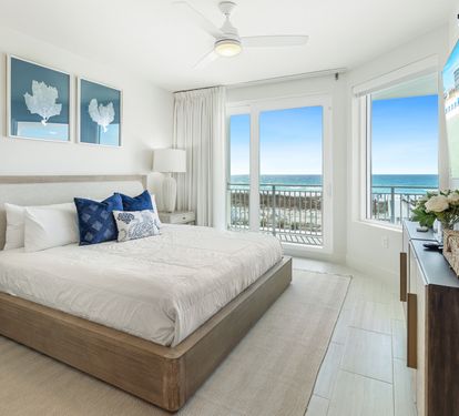 Wake up to endless ocean views from your serene bedroom sanctuary, where coastal blues meet crisp whites for the perfect beach retreat.
