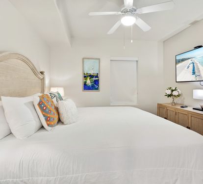 Drift off in your coastal bedroom, where crisp white linens and ocean artwork create a serene sanctuary for restful nights.