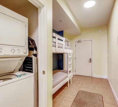 Hall houses bunk area and W/D closet