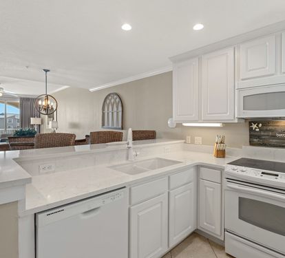 The kitchen features stainless appliances, perfect for preparing meals while enjoying the open layout.
