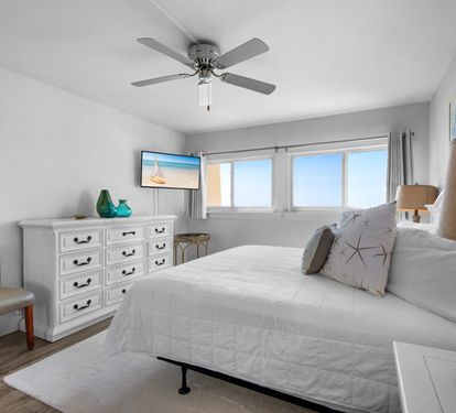 Primary bedroom with king bed and a view