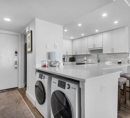 Kitchen with plenty of counter space and convenient laundry center