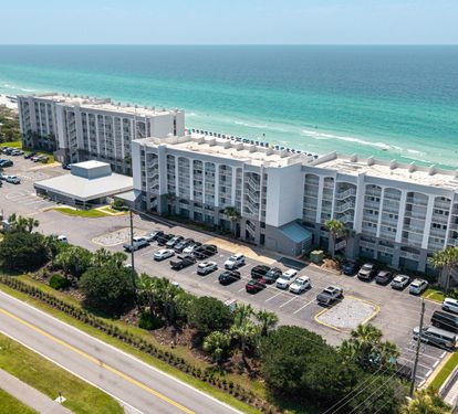 Beachfront property located directly on pristine white sand shores with stunning turquoise waters stretching to the horizon.