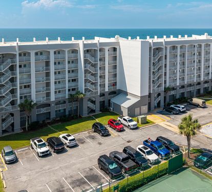 Beachfront property with direct access to pristine white sands and emerald waters, with convenient parking and outdoor amenities for your coastal getaway.