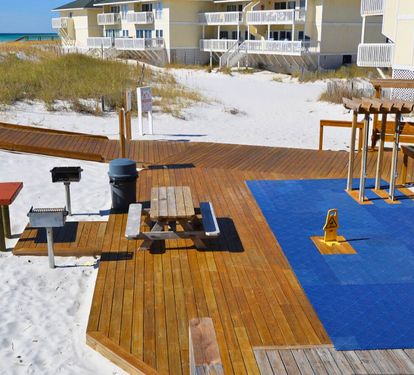 Outdoor picnic and grilling area at Sandpiper Cove Resort, surrounded by sugar-white dunes—perfect for casual cookouts, relaxed gatherings, and coastal downtime just steps from the beach.