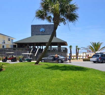 Coastal beachfront area with tropical palms and nearby amenities for a convenient beach vacation experience.