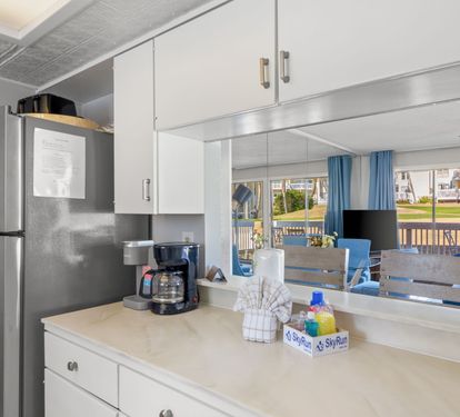 Enjoy the kitchen coffee station and open pass-through design connecting the kitchen to the living area. A bright, welcoming space perfect for morning coffee, casual meals, and easy gathering throughout your stay.