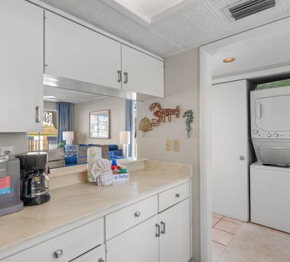 The kitchen offers ample cabinet space, a convenient coffee station, and an open layout that keeps everyone connected throughout the living and dining areas. A stacked washer and dryer are also included for added convenience during your stay.