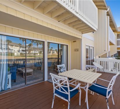 Your private balcony offers the perfect spot for morning coffee or sunset dining, with comfortable seating and serene waterfront views just beyond the railing.