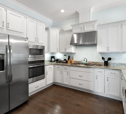 Your fully-equipped kitchen features gleaming granite counters, stainless steel appliances, and pristine white cabinetry—perfect for preparing memorable meals during your stay.