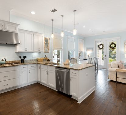 Prepare your favorite meals in this bright, fully-equipped kitchen with granite countertops, stainless appliances, and an island perfect for gathering.