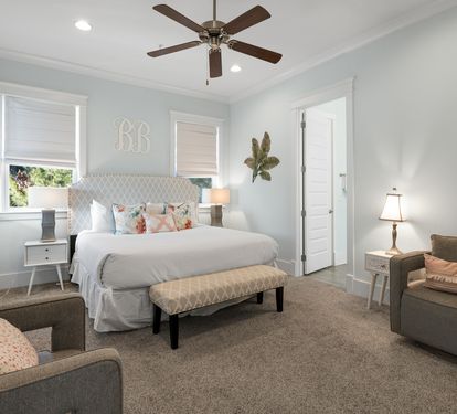 Sink into this serene bedroom where soft linens and plush seating create your perfect retreat after exploring the area.