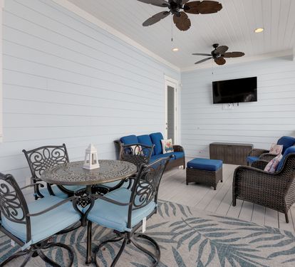 Relax on your private covered porch with comfy seating, ceiling fans, and entertainment—perfect for morning coffee or evening unwinding.