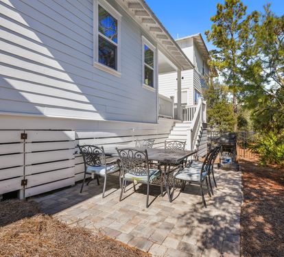 Your private patio offers the perfect spot for morning coffee or evening gatherings under dappled shade.