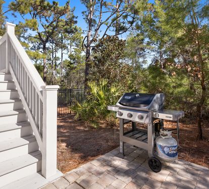 Fire up the grill and savor outdoor cooking surrounded by lush coastal pines, just steps from your deck.