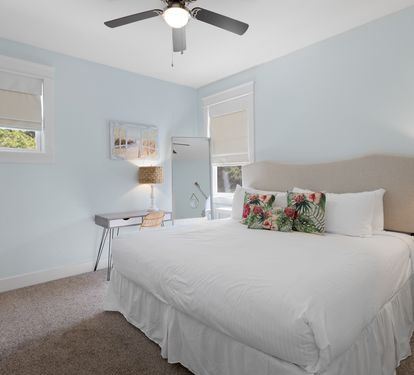 Rest peacefully in your serene bedroom with soft blue walls, crisp white linens, and natural light streaming through your windows.