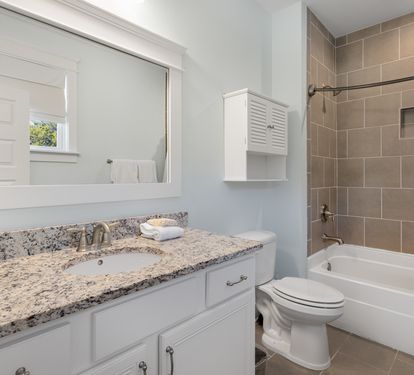 Unwind in your beautifully appointed bathroom featuring granite counters, a soaking tub, and elegant tile work for your comfort.