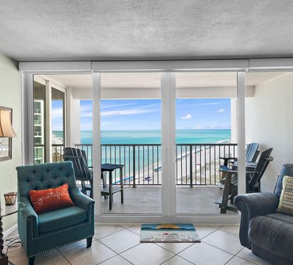 Step into your oceanfront living room where turquoise waters fill every window and your private balcony awaits with stunning sea views.