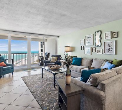 Relax in your spacious living room with plush seating and stunning ocean views right outside your door.