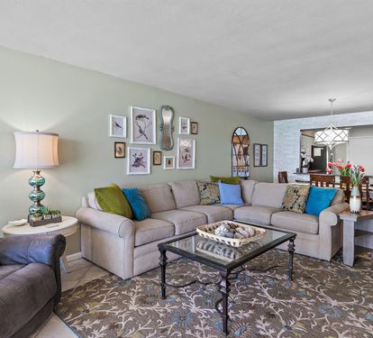 Settle into your spacious living area with plush sectional seating, colorful accent pillows, and thoughtful touches that make you feel right at home.