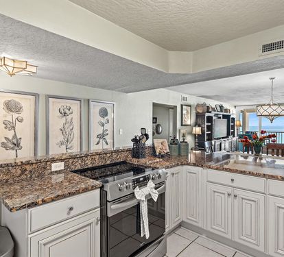 Prepare meals in your well-equipped kitchen while enjoying stunning ocean views through the open living area.