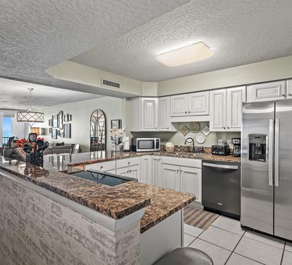 Your fully equipped kitchen features granite countertops, stainless steel appliances, and stunning ocean views for memorable meal prep.