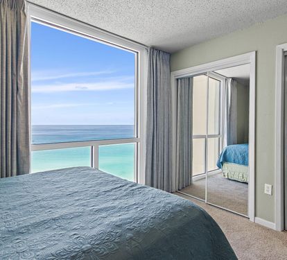 Wake up to breathtaking ocean views from your master bedroom, where turquoise waters stretch endlessly beyond floor-to-ceiling windows.
