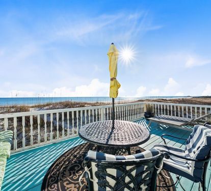 Your private beachfront deck offers stunning ocean views with comfortable seating for morning coffee or sunset cocktails.