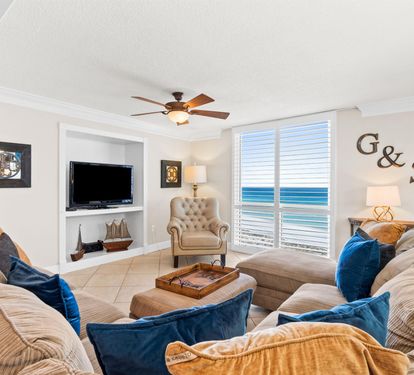Unwind in your elegant living room where plush sectional seating and ocean views create the perfect retreat for relaxation.