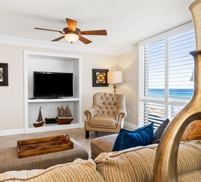 Relax in comfort with ocean views streaming through your window, cozy seating, and gentle sea breezes from the ceiling fan.