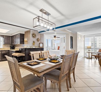 Gather around your stylish dining table in this open-concept space, where the modern kitchen beckons for morning coffee and memorable meals together.