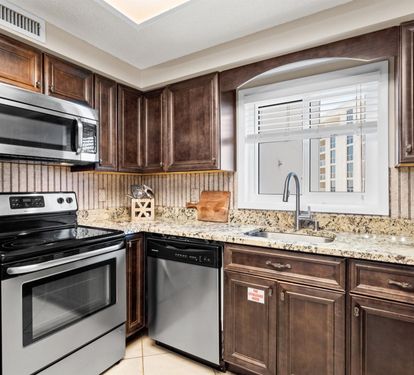 Your gourmet kitchen awaits with rich wood cabinetry, granite countertops, and stainless steel appliances for memorable meal preparations.