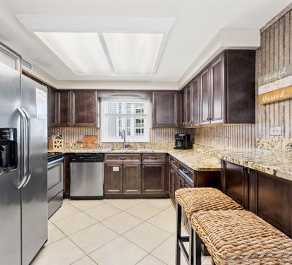 Your fully equipped kitchen features granite counters, stainless appliances, and warm wood cabinets for effortless meal preparation.