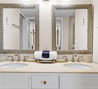 Refresh in your elegant dual-vanity bathroom with rope-framed mirrors and thoughtful amenities for your morning routine.
