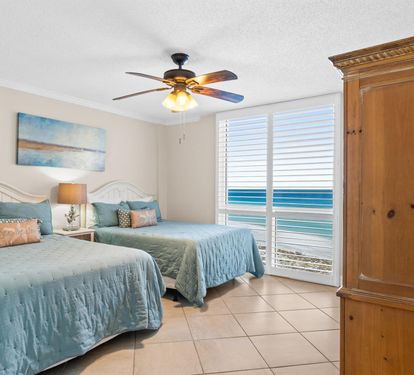 Wake up to ocean waves just outside your window in this coastal bedroom with twin beds and soothing sea-inspired decor.