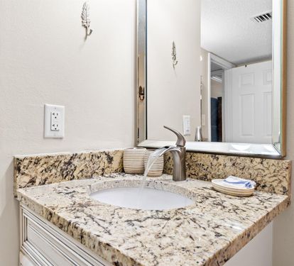 Step into your elegantly appointed bathroom featuring granite countertops and fresh towels awaiting your arrival.