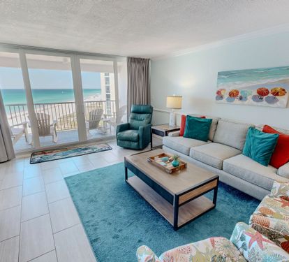 Sink into plush seating while ocean breezes flow through your private balcony doors, creating the perfect beachfront sanctuary.
