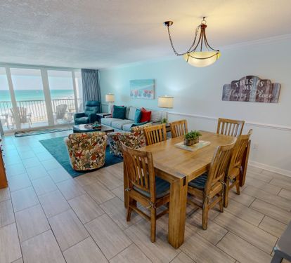 Gather around your spacious dining table with ocean views streaming through floor-to-ceiling windows, creating the perfect setting for memorable beachside meals.